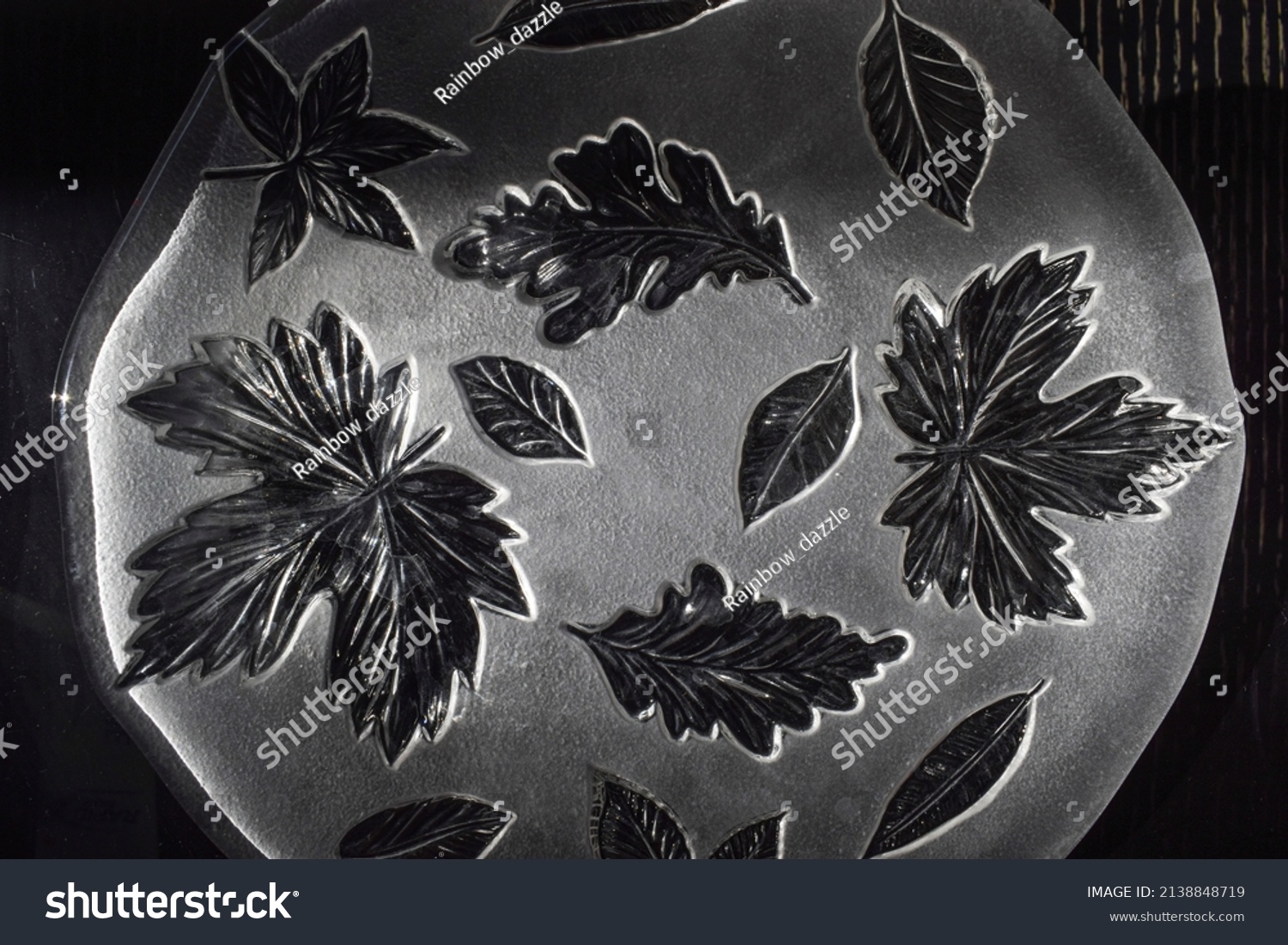 Glass leaf design etched background. Backdrop of beautiful transparent glass pattern of leaf design #2138848719
