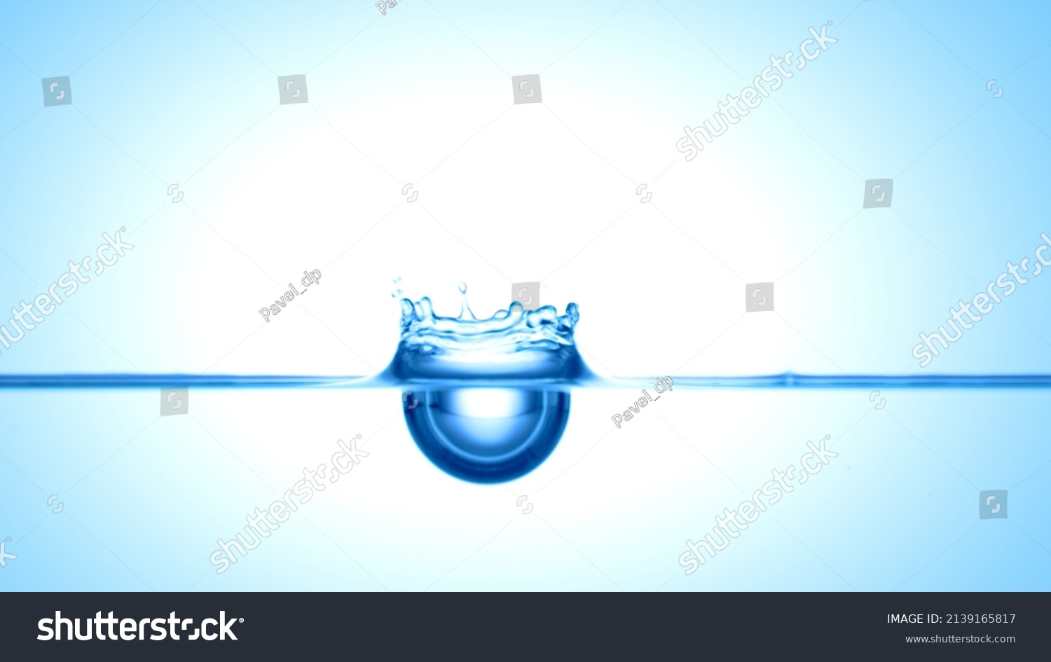 Blue drop falls down on blue transparent liquid creating a crown on it's surface | Abstract skin moisturizing cosmetics mixing concept #2139165817