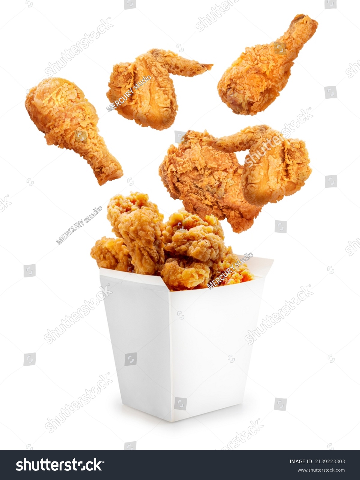 Fried chicken flying out of paper bucket isolated on white background, Fried chicken on white With clipping path. #2139223303