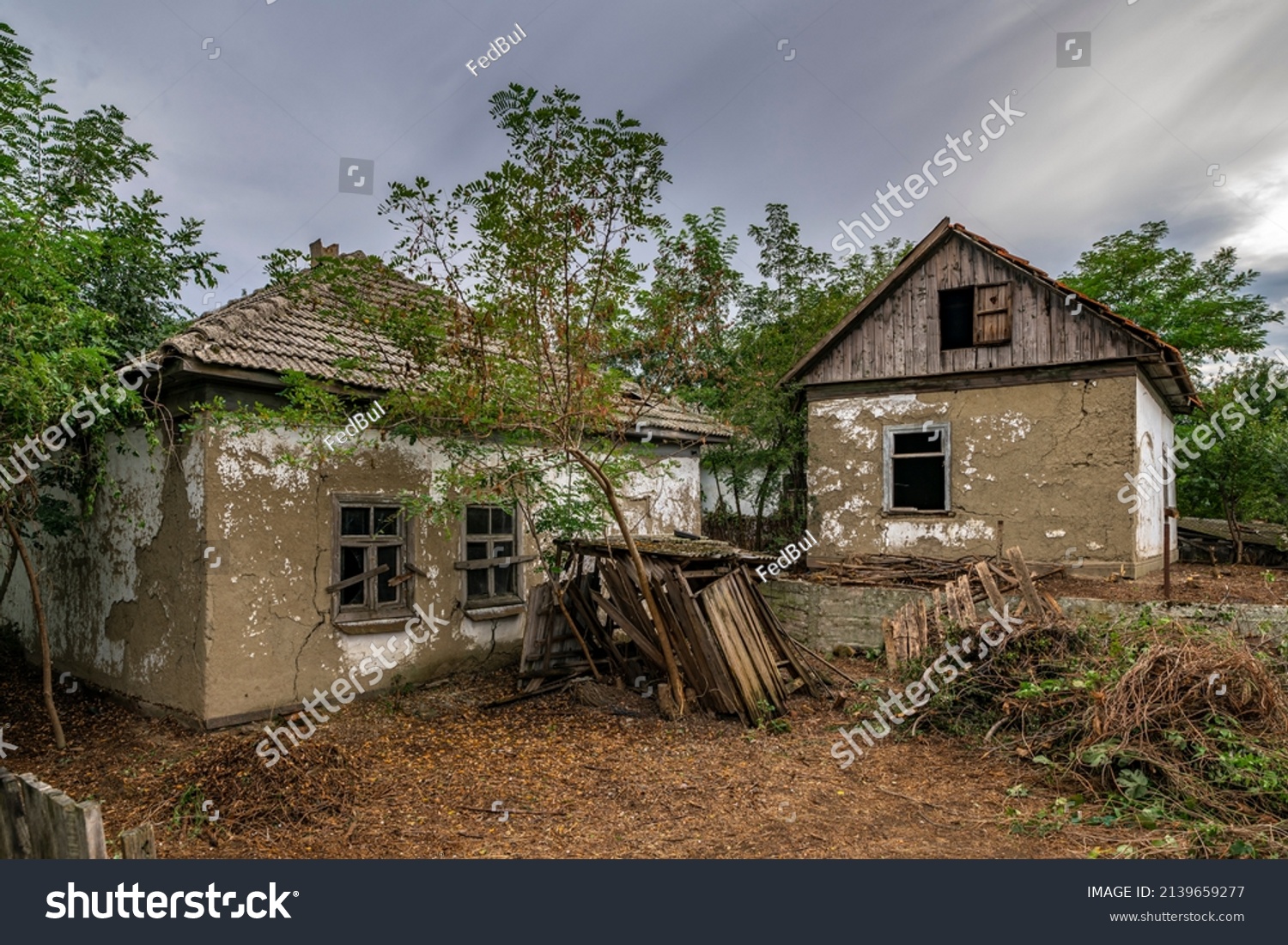 Old abandoned ruined house in dead village. Deserted and destroyed dwelling on farm yard. Neglected building countryside #2139659277