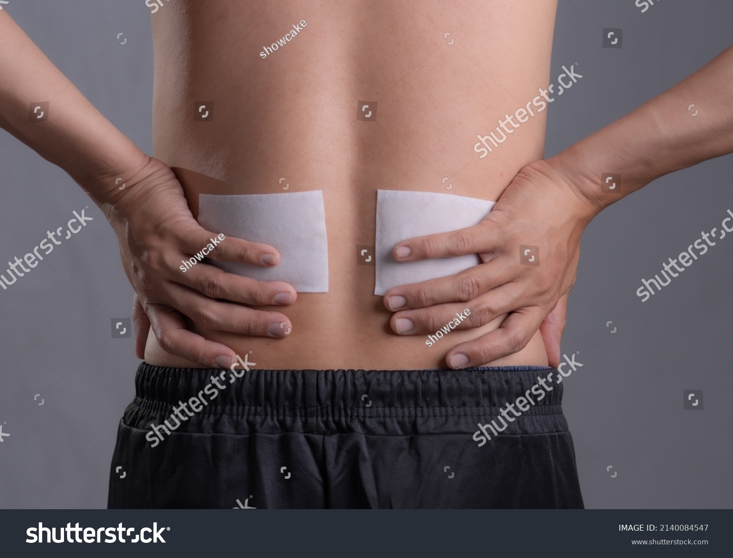 Medicated pain relief patch with man pain Lower Back,office syndrome,Health problems from overworked concept. #2140084547