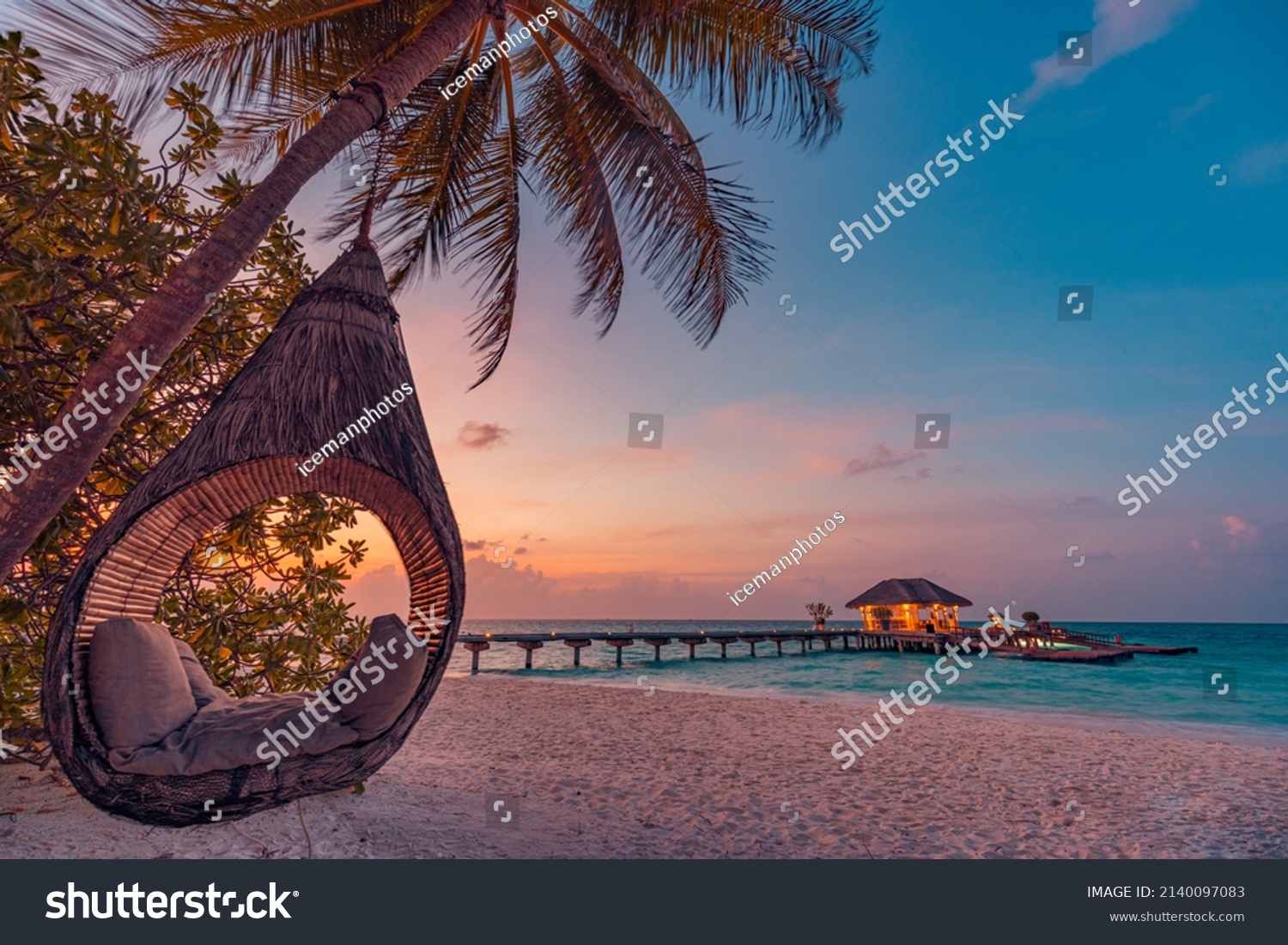 Tropical sunset beach background, summer island landscape with beach swing or hammock and sand romantic sea beach. Beautiful beach scene vacation or summer holiday concept. Honeymoon, romance resort #2140097083