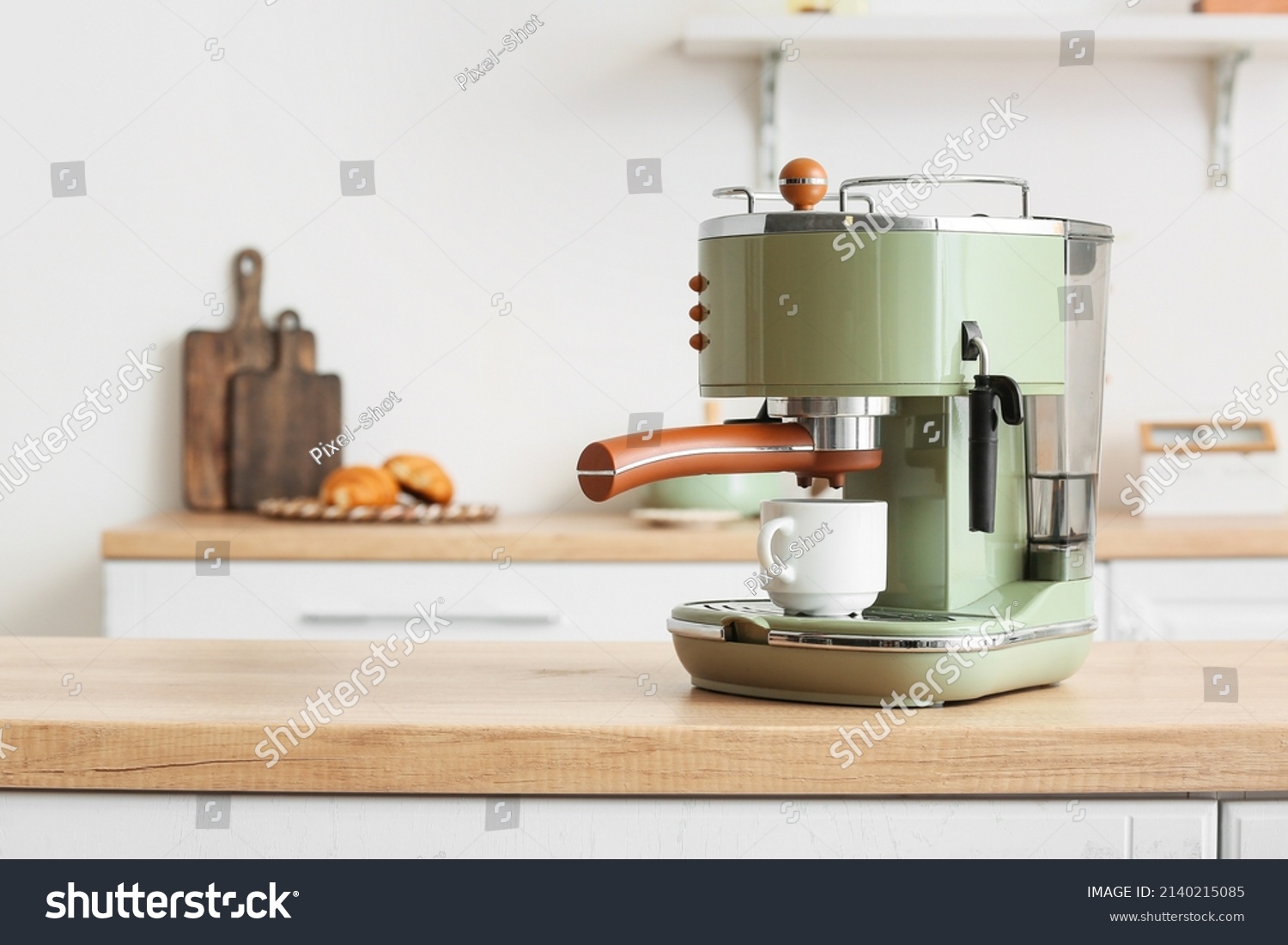 Modern coffee machine with cup on counter in kitchen #2140215085