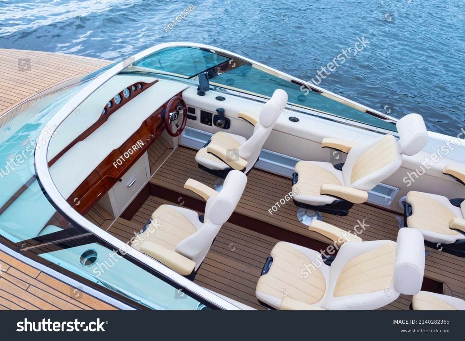 Speedy motor boat. Boat trips. An empty cabin of a motor boat. Leather seats and wooden trim of a luxury yacht. Sale of passenger ships. Recreation on the water. #2140282365