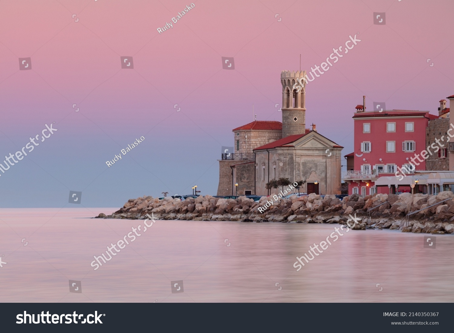 Piran, Slovenia. Cityscape image of Piran, Slovenia with historical church and lighthouse at sunrise. #2140350367