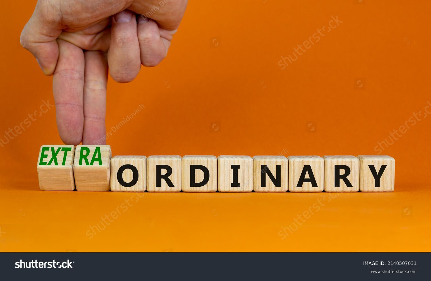 Ordinary or extraordinary symbol. Businessman turnes wooden cubes and changes words 'Ordinary extraordinary'. Beautiful orange background. Business, ordinary or extraordinary concept. Copy space. #2140507031