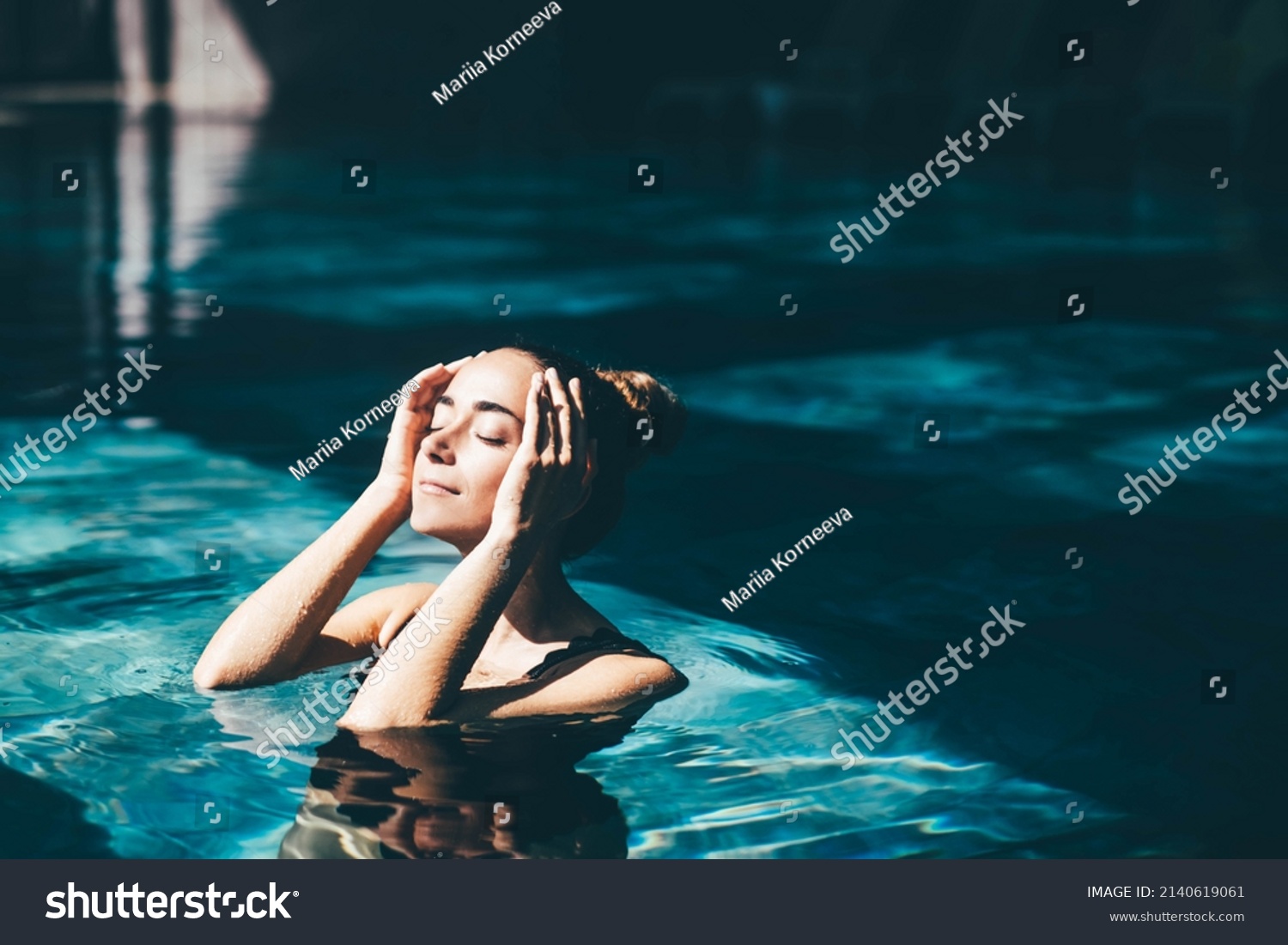 Woman relaxing in the swimming pool. #2140619061