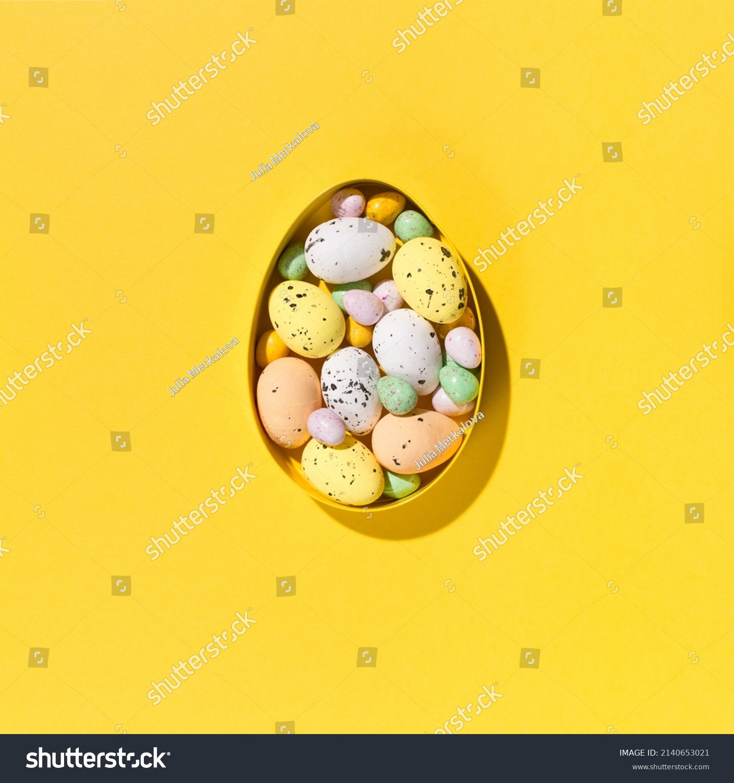 Festive holiday Easter composition. Yellow, pink, blue and white easter eggs on paper yellow background. Spring Easter card concept. Flat lay, top view, copy space. #2140653021