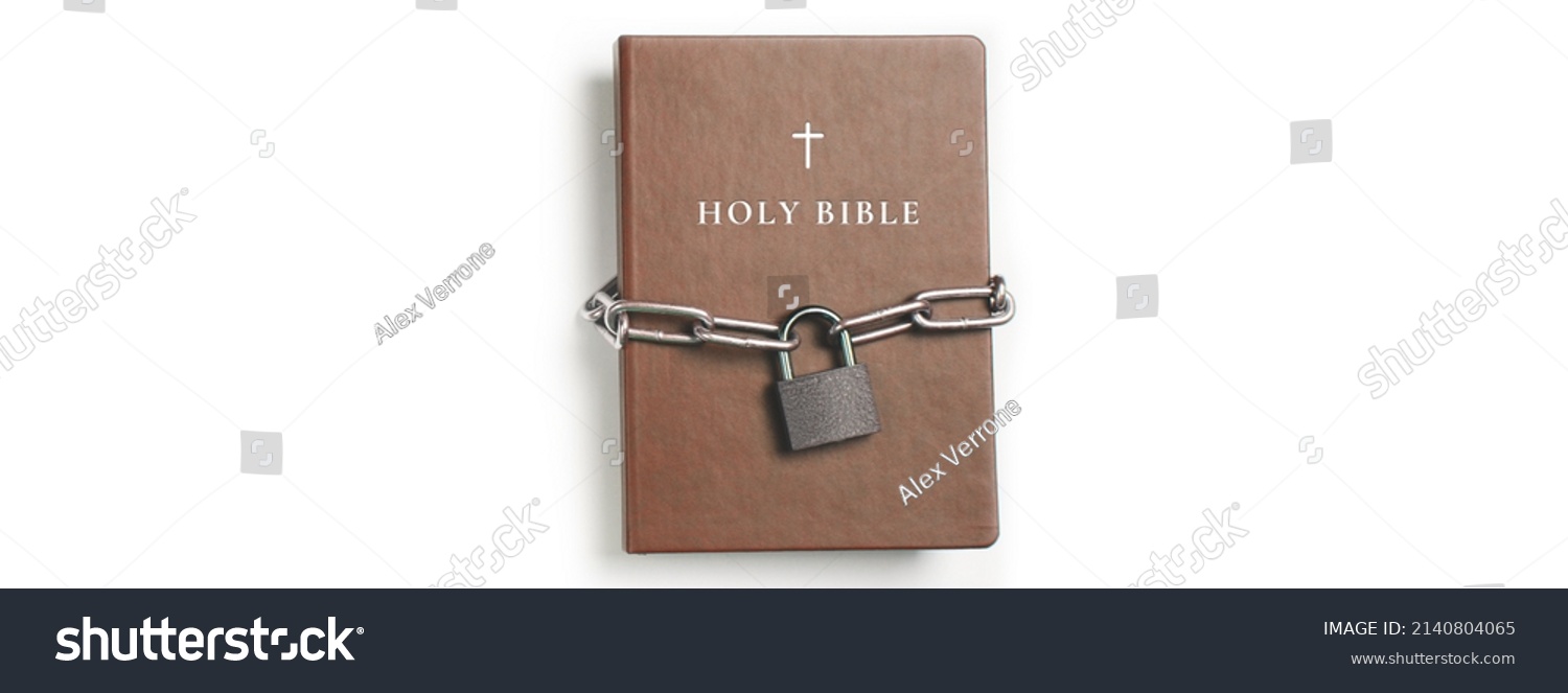 Bible. Book with lock. A closed book is banned. Chain and padlock wrapped the book. #2140804065