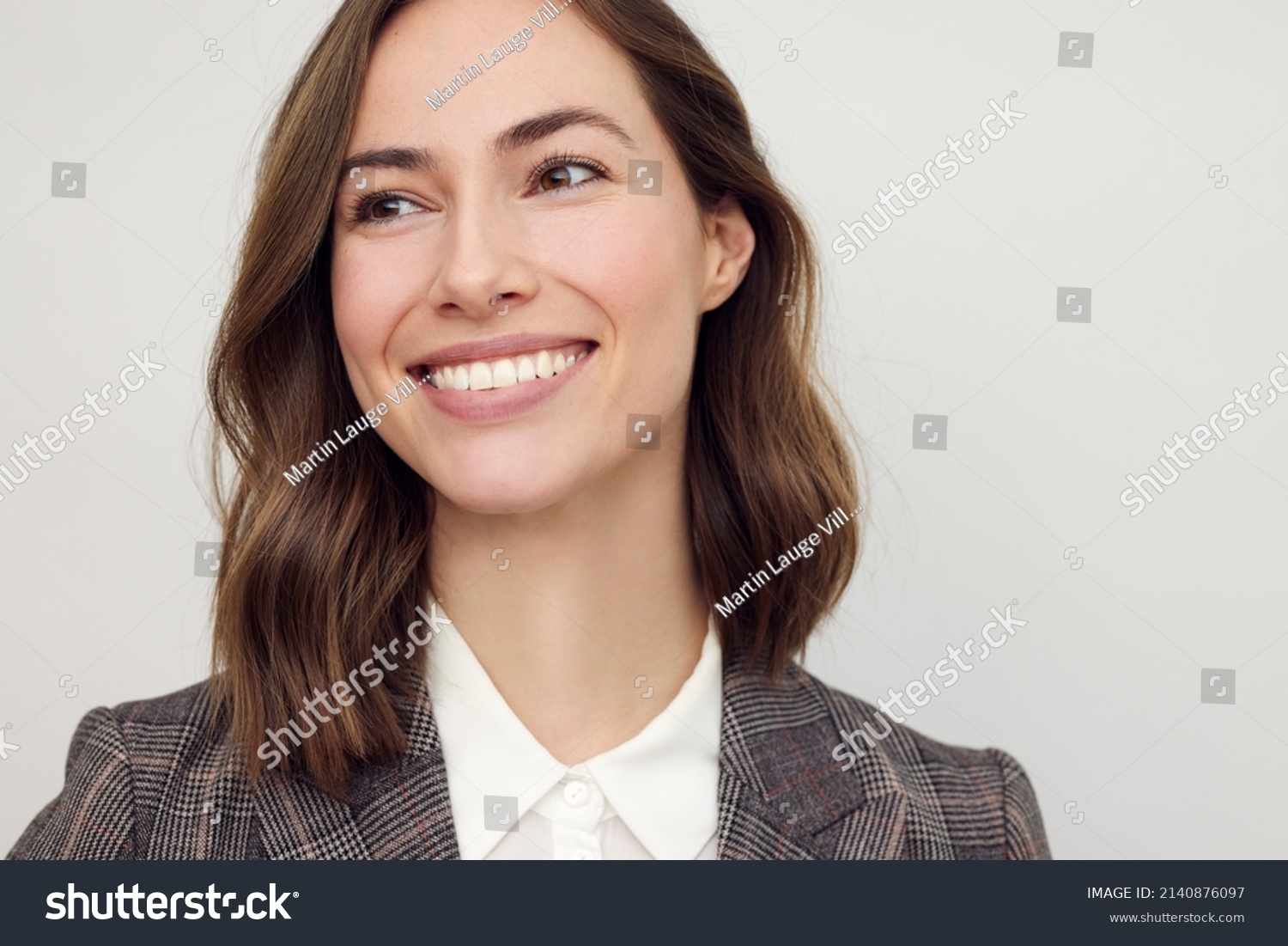 Close-up portrait of beautiful young businesswoman looking happy and confident to the left. Big smile on her face, looking beautiful and cheerful standing isolated on white background. #2140876097