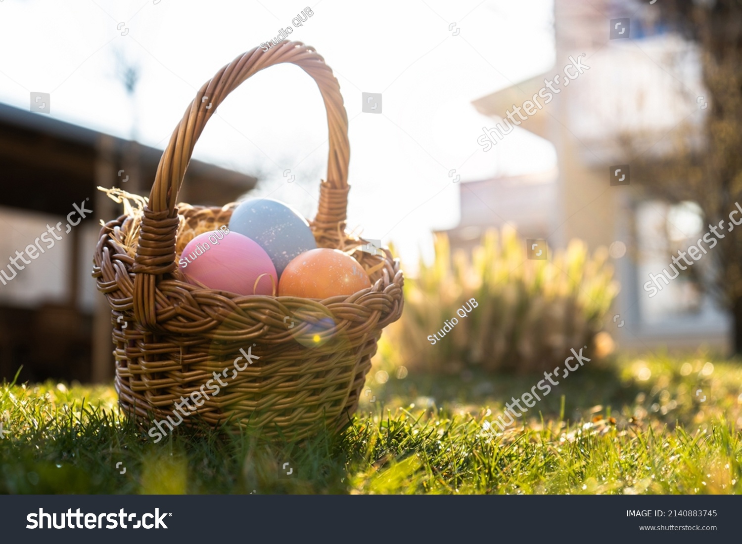 Happy Easter. Basket with Easter eggs in grass on a sunny spring day - Easter decoration, banner, panorama, background with copy space for text. #2140883745