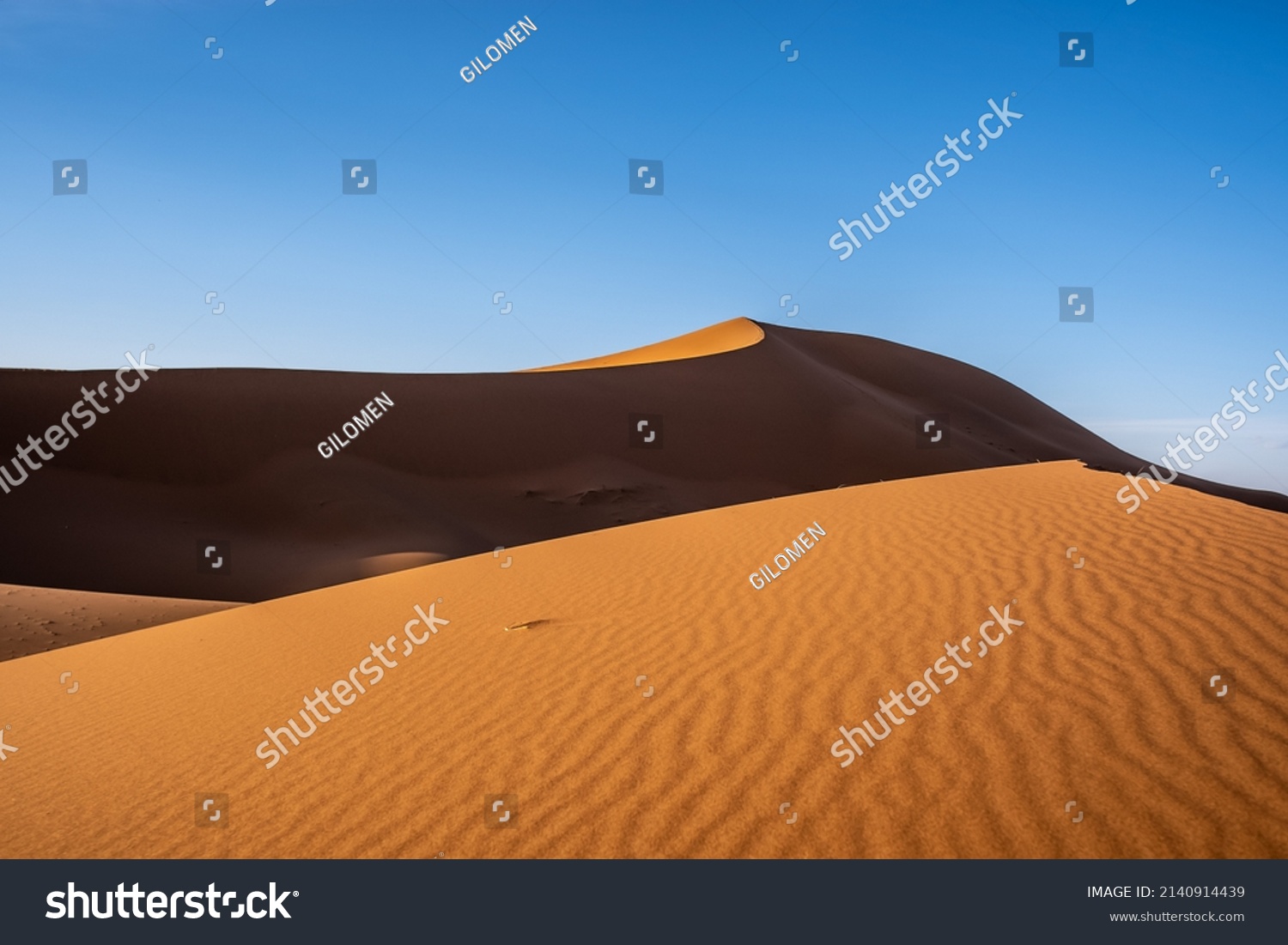 The blue sky and the desert seem to blend together #2140914439