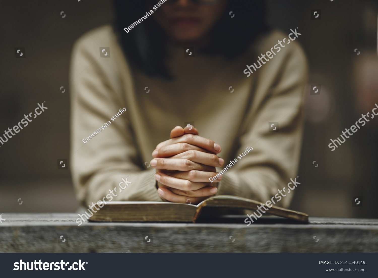 Christian life crisis prayer to god. Woman holding hands pray for god blessing to wishing have a better life on a wooden table. Woman hands praying to god with the bible. believe in goodness. #2141540149