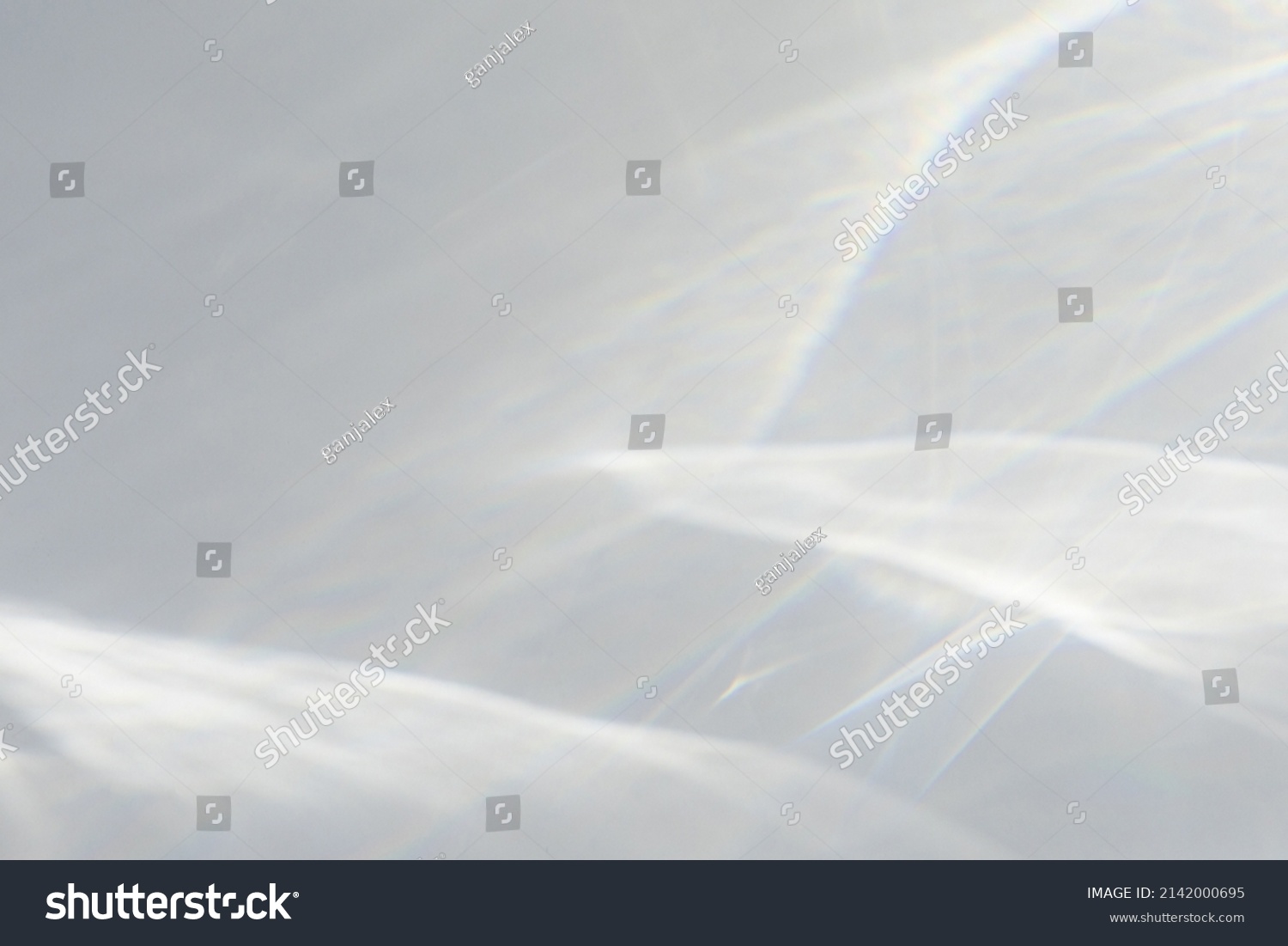 Blurred water texture overlay effect for photo and mockups. Organic drop diagonal shadow caustic effect with rainbow refraction of light on a white wall. Shadows for natural light effects #2142000695