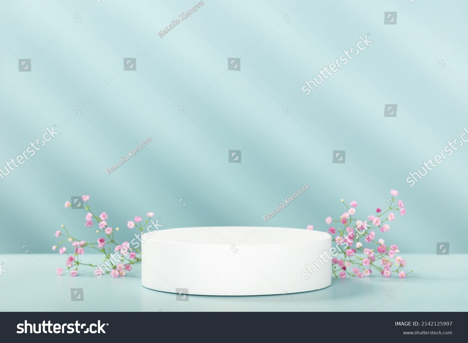 Abstract empty white podium with geometric shadows and pink flowers on blue background. Mock up stand for product presentation. 3D Render. Minimal concept. Advertising template #2142125997