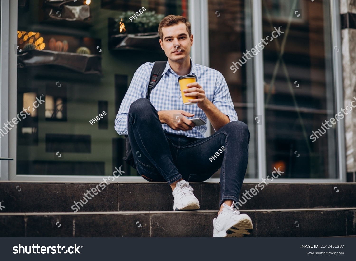 Young handsome man drinking coffee outside #2142401287