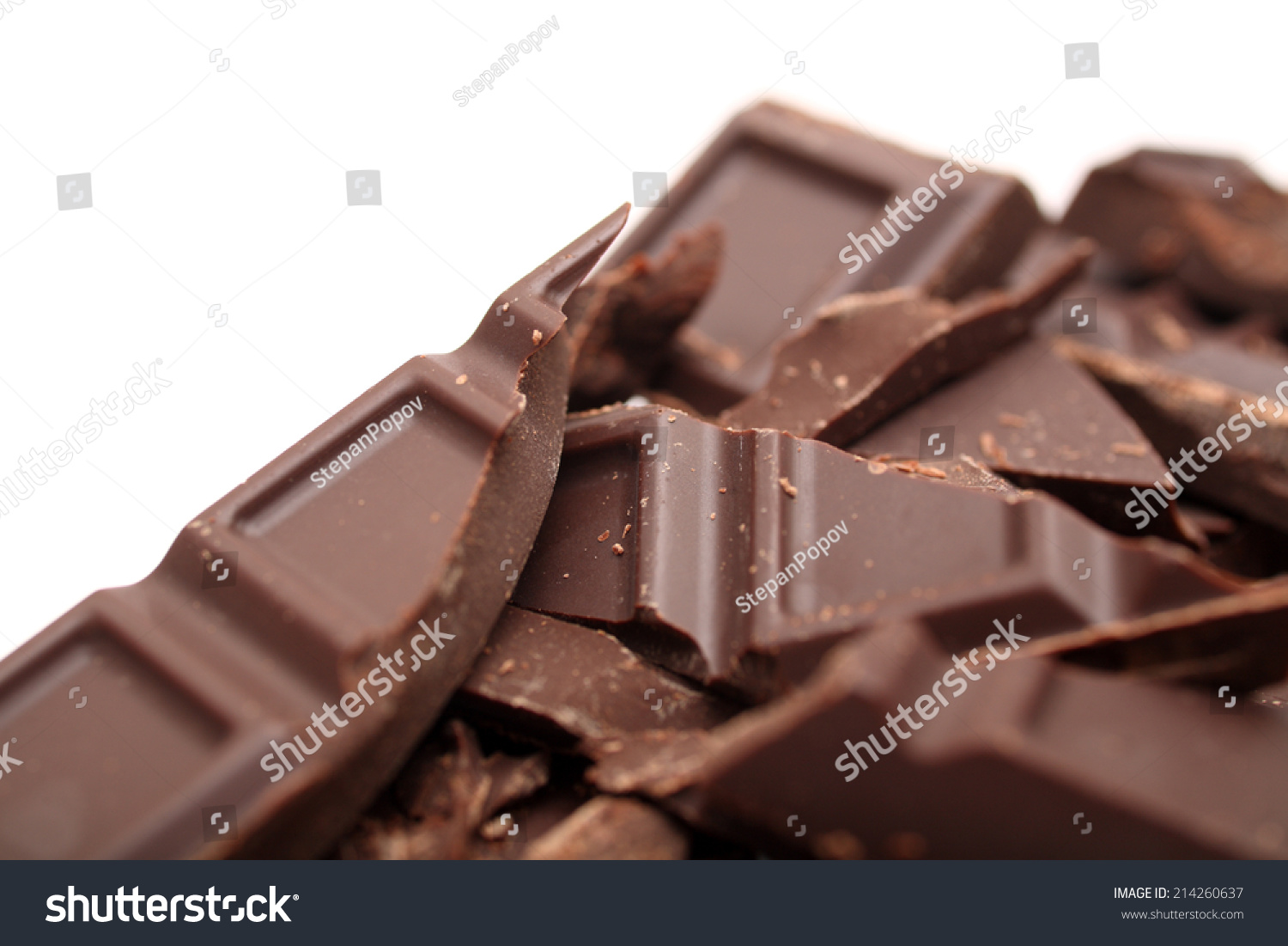 Pieces of chocolate on white background. Closeup. #214260637