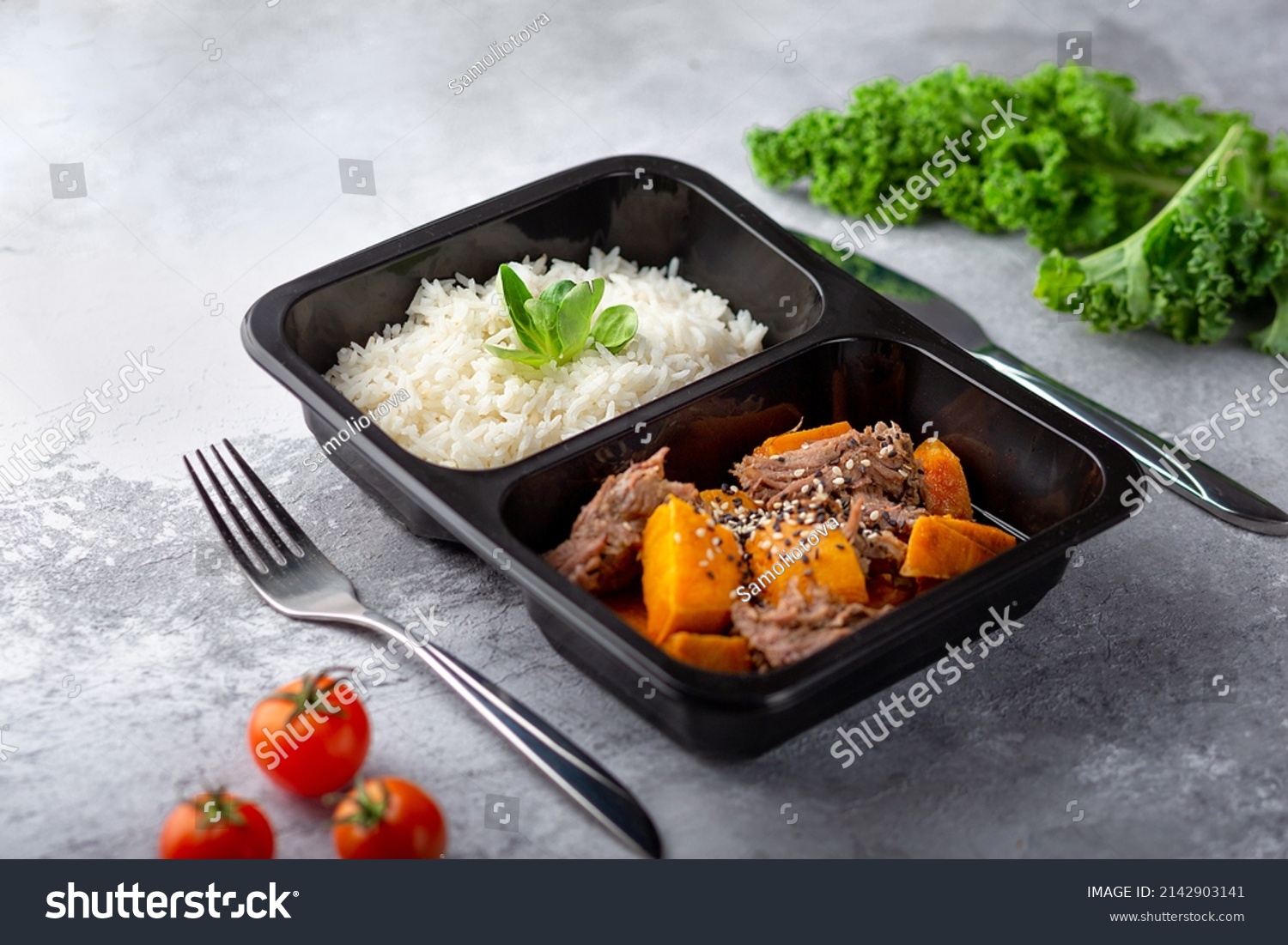 a dish in a black disposable container from catering on a concrete background, dietary catering, ready meals with you, healthy food #2142903141