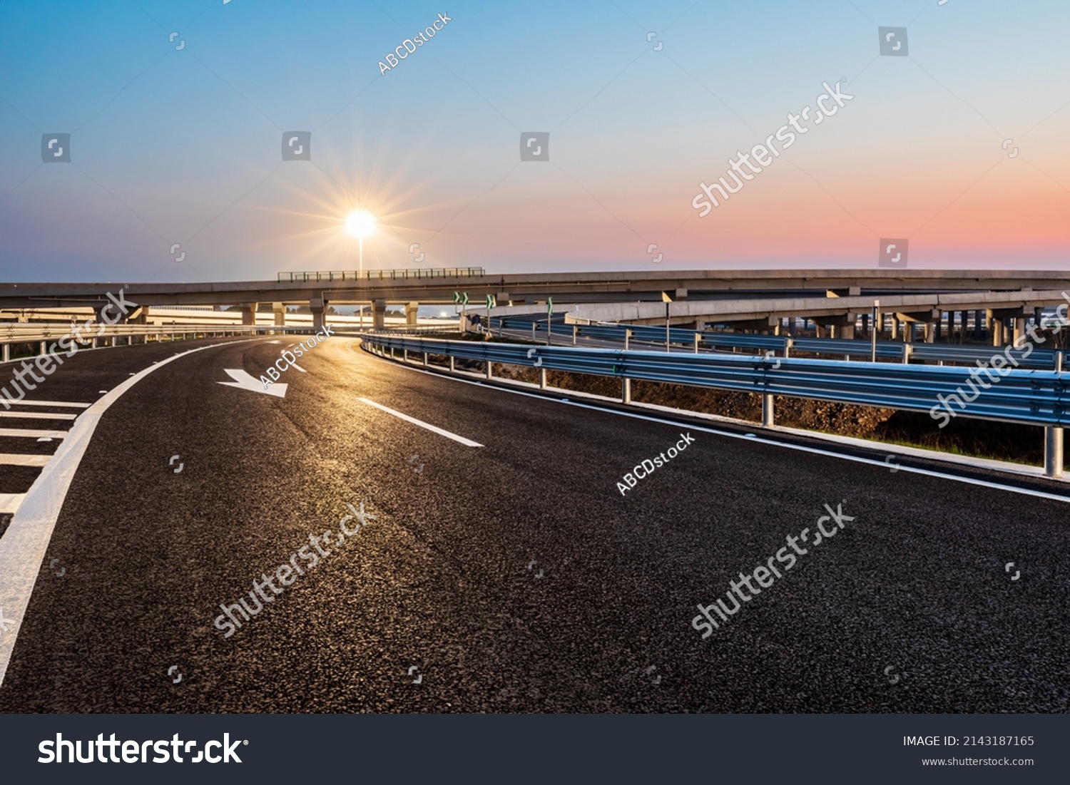 Empty asphalt highway and street lights with beautiful sky at sunset #2143187165