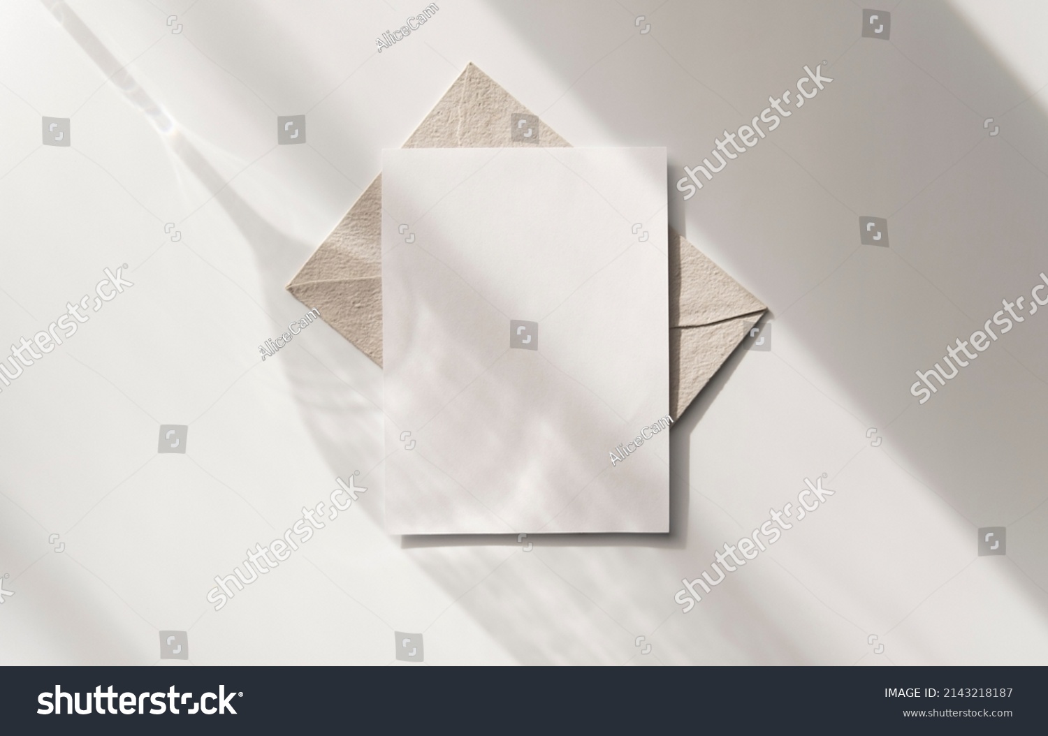 Mockup blank greeting card. Composition with shadows from a glass goblet on white background.  #2143218187