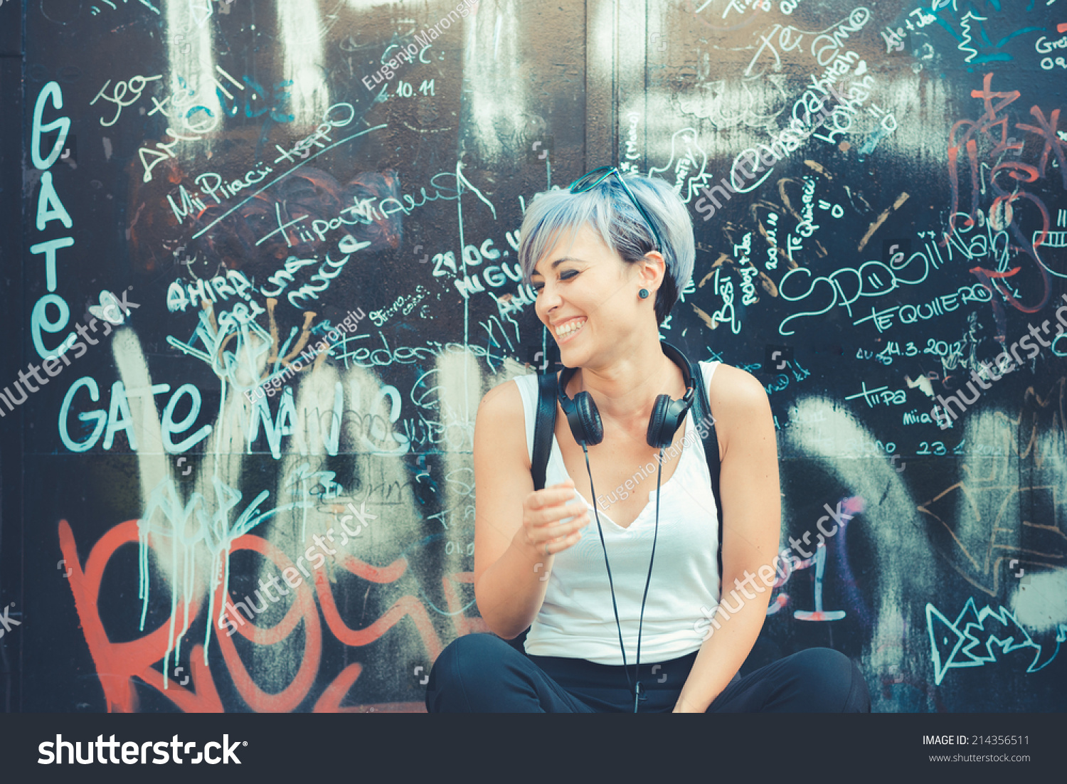 young beautiful short blue hair hipster woman with headphones music in the city #214356511