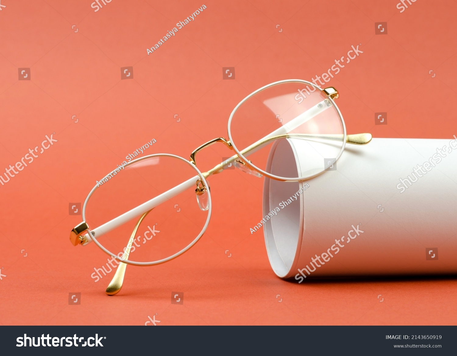 Stylish women's eyeglasses in a white frame on an orange background #2143650919