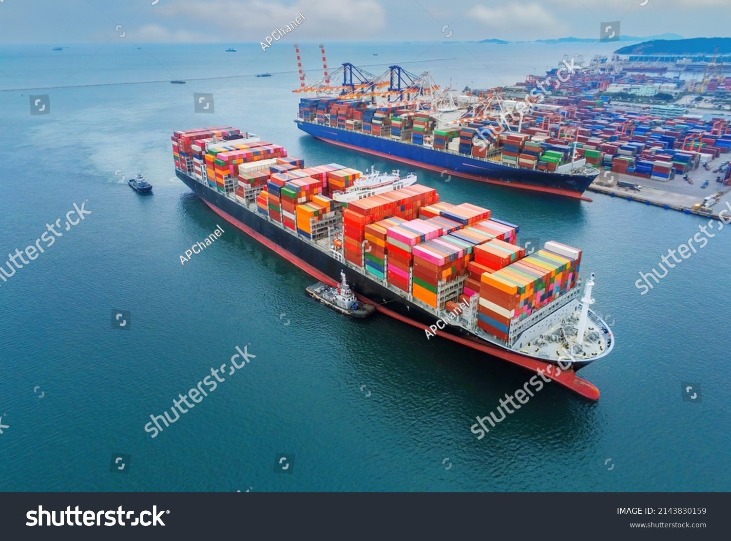 Arial view by drone camera transportation logistics and container dock cargo yard with working crane bridge in shipyard with transport logistic import export with blue sky background. #2143830159
