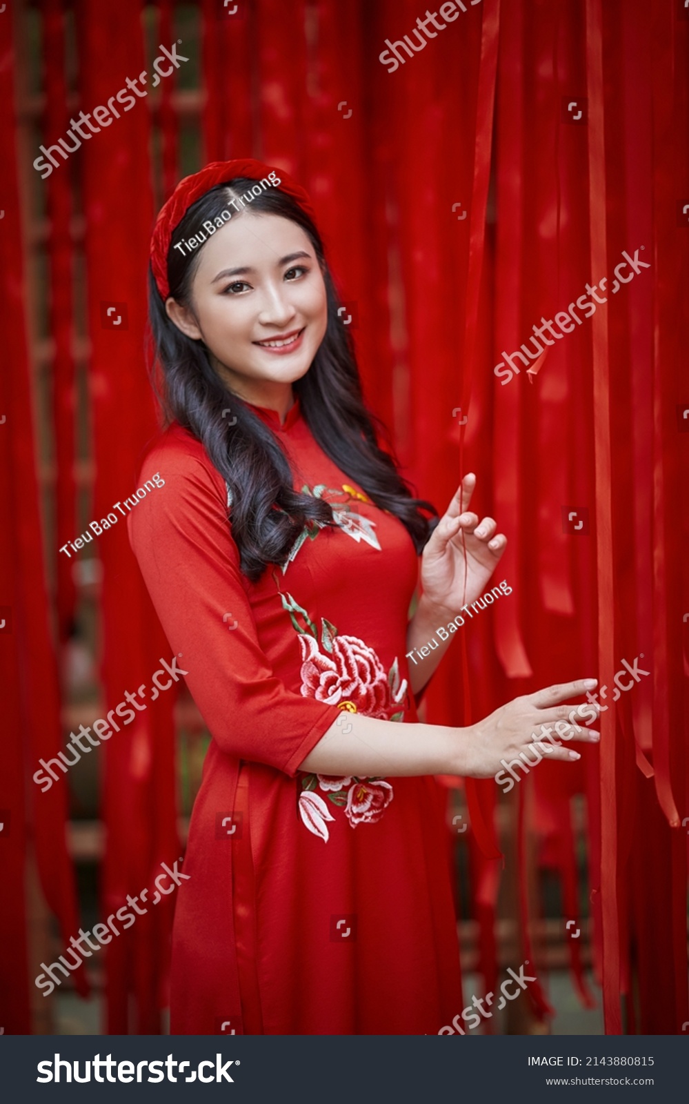 Ho Chi Minh City, Vietnam: Portrait of a brilliant Vietnamese girl in a red ao dai to welcome the Vietnamese traditional New Year #2143880815