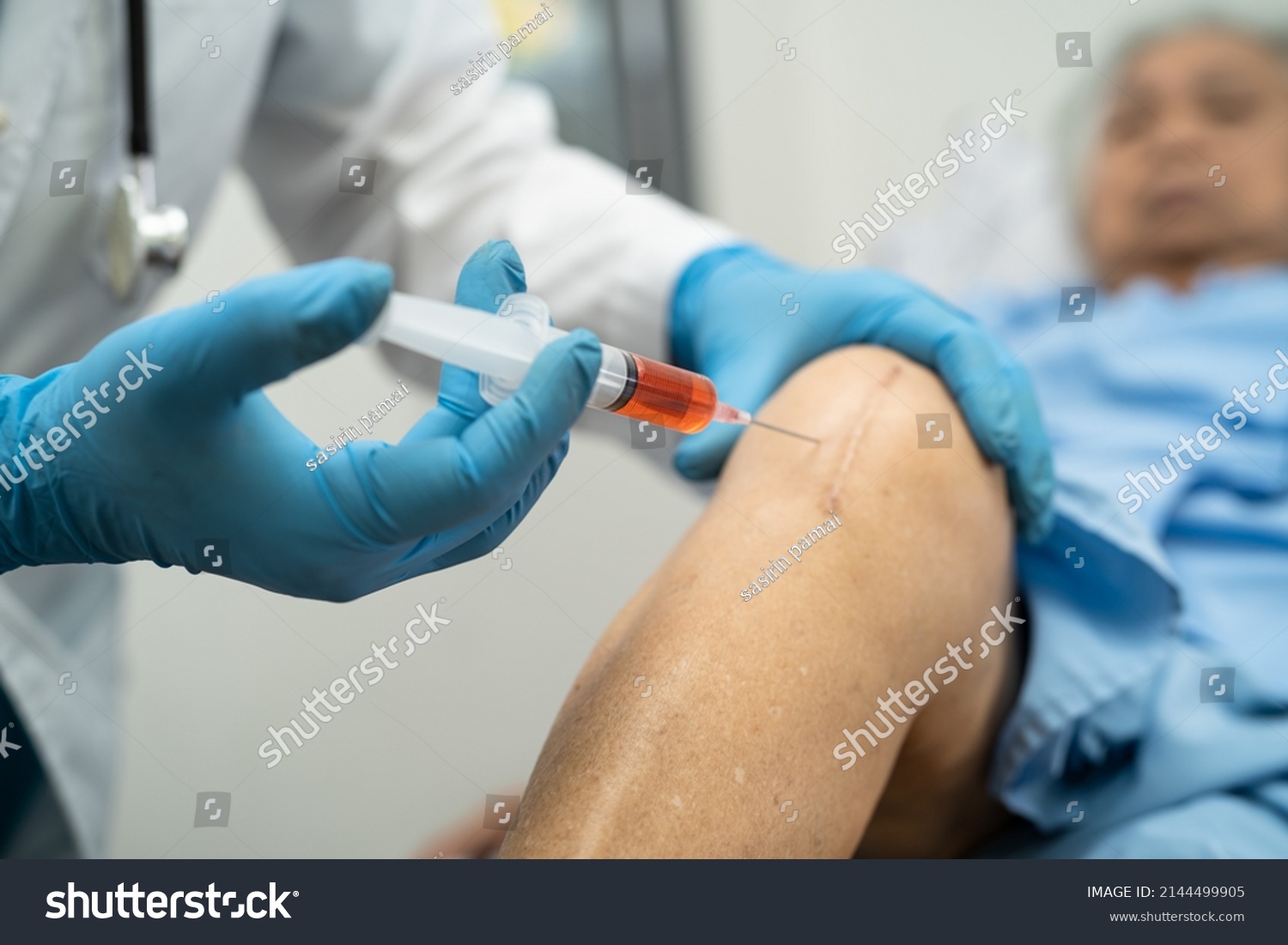 Asian doctor inject Hyaluronic acid platelet rich plasma into the knee of senior woman to walk without pain. #2144499905