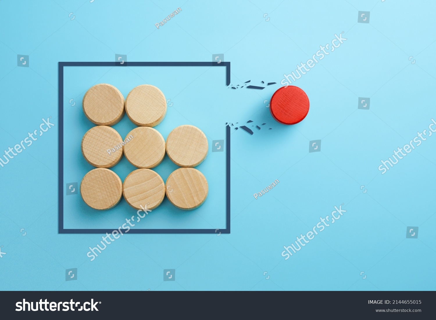 Concept of overcoming barriers, goal, target. Red wooden cube breaking through obstacle on blue background #2144655015