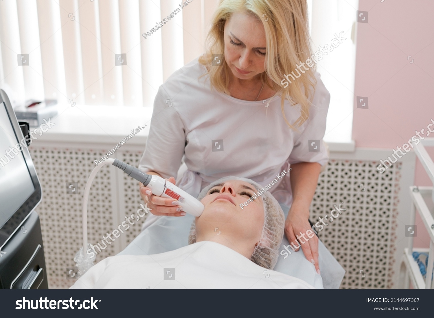 Rejuvenation facial treatment isolated on white. Model gets lifting therapy massage at SPA beauty salon. Exfoliate, rejuvenate and hydrate. Cosmetology. Close up, selective focus. #2144697307
