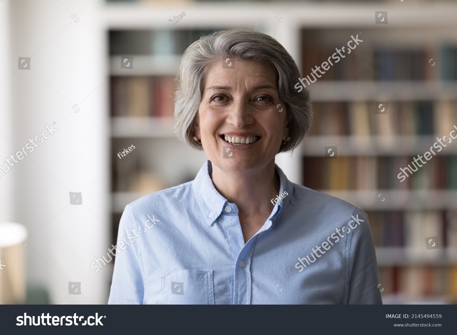 Head shot portrait of happy middle aged old hoary attractive successful businesswoman entrepreneur employee posing in modern home office, professional corporate career, female leadership concept. #2145494559