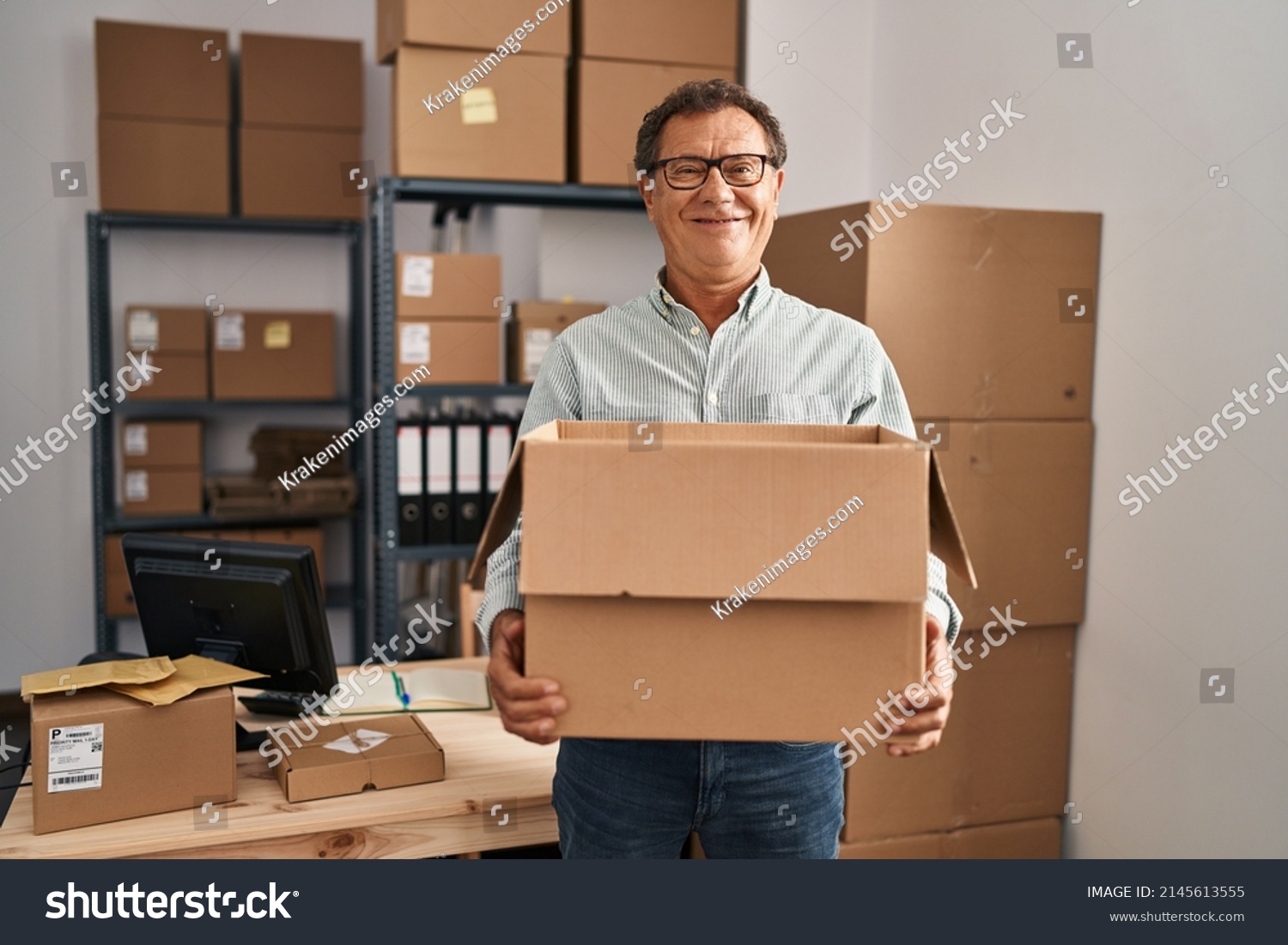 Senior man working at small business ecommerce holding carboard bx smiling with a happy and cool smile on face. showing teeth.  #2145613555