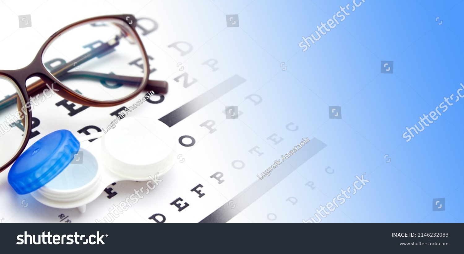 Contact lenses case and eye glasses on and eye test chart. Vision concept. Way to improve vision #2146232083