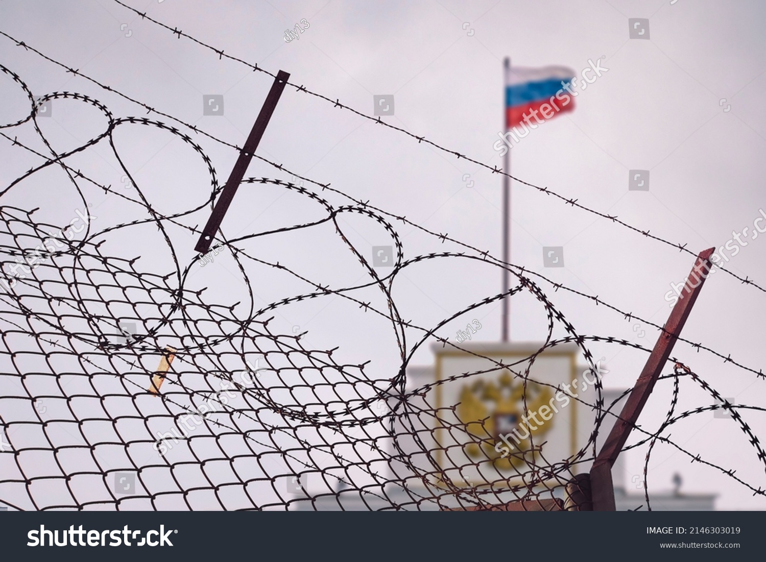 The concept of European and US sanctions pressure on the Russian Federation government. flag of the Russian Federation in barbed wire, sanctions and aggression of Russia. Russian prison #2146303019