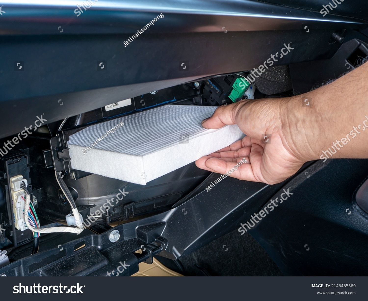 Replacement air filter for car. Hand of the car user for maintenance airconditioner filter by replacement concept DIY inside his car #2146465589