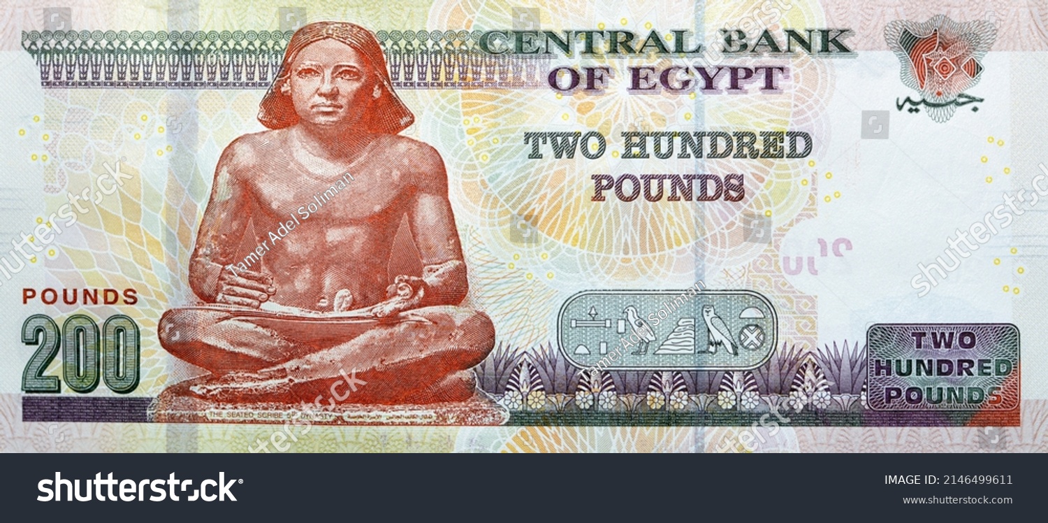 Large fragment of the reverse side of 200 LE two hundred Egyptian pounds banknote series 2021 features The Seated Scribe, selective focus of Egypt cash money bill by central bank of Egypt #2146499611