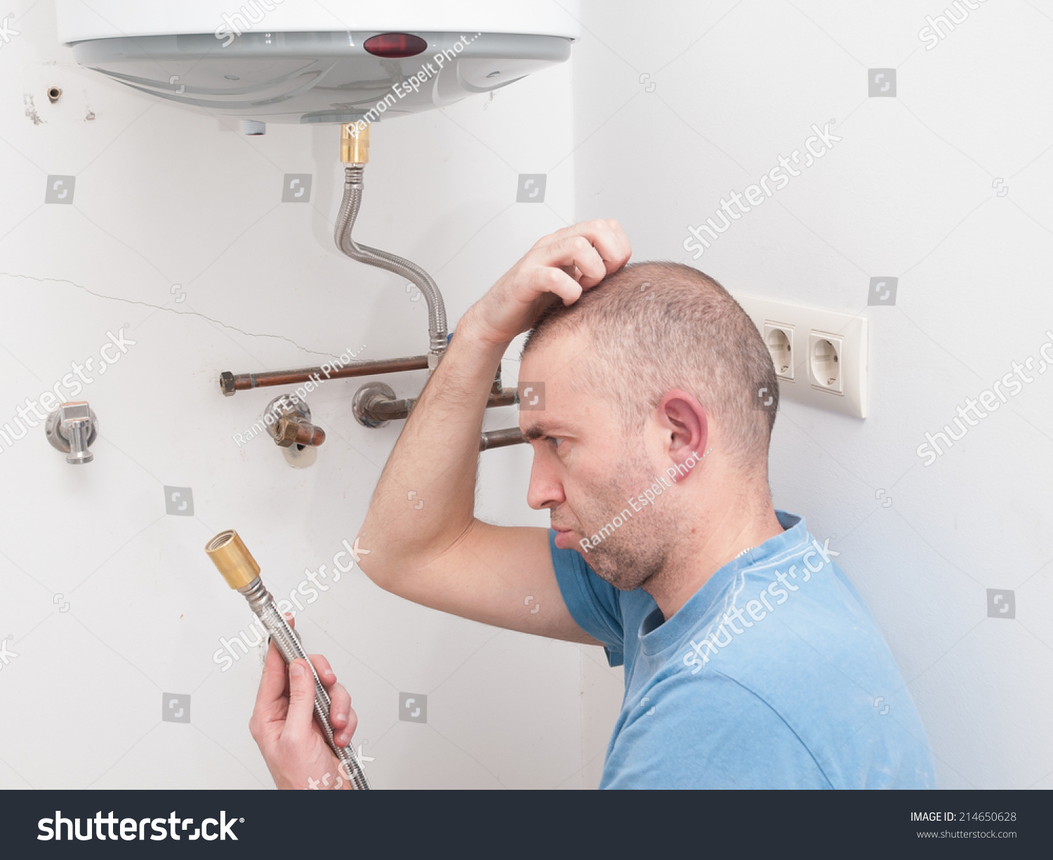 Inexperienced plumber trying to repair an electric water heater #214650628
