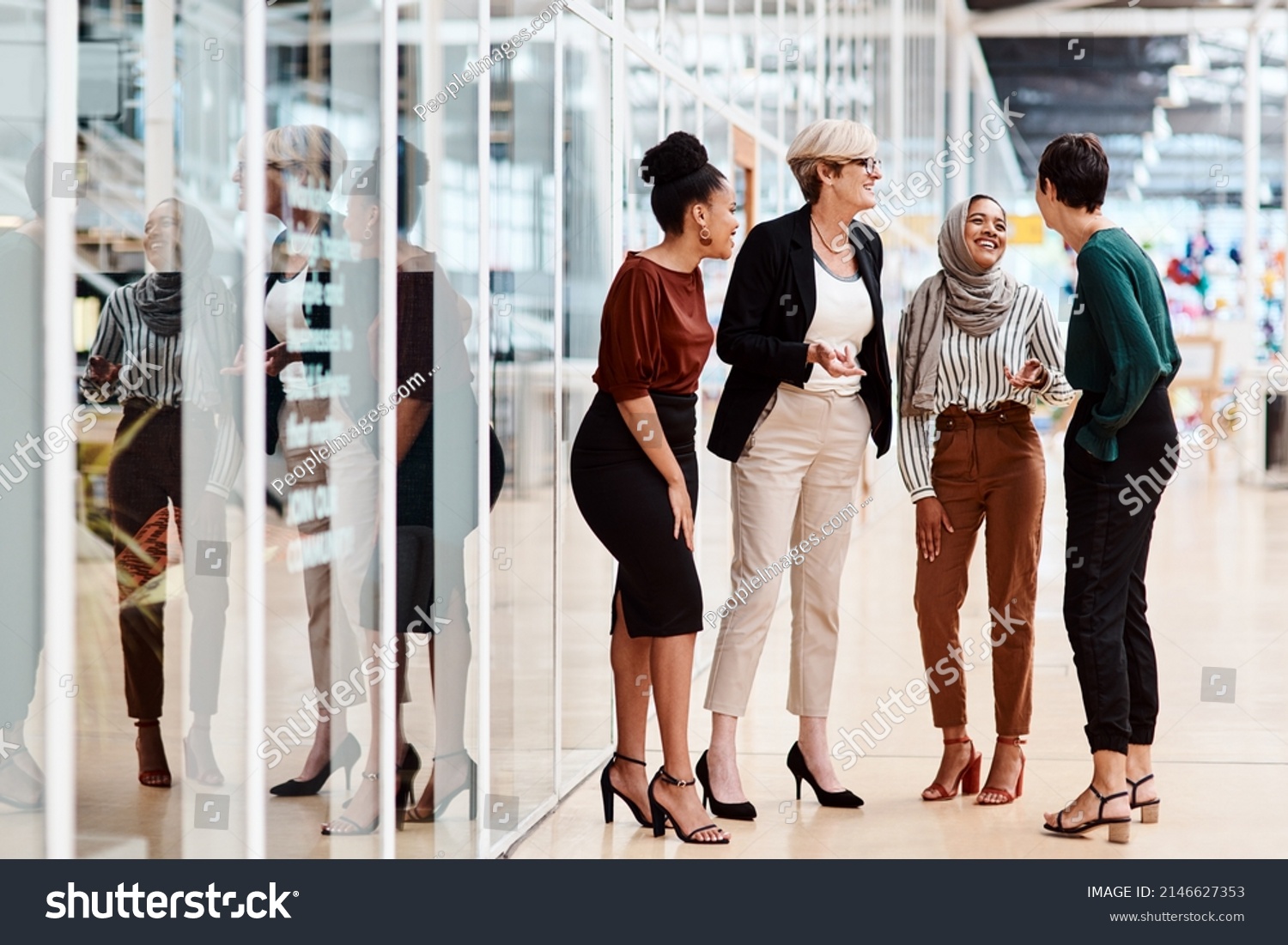 They share a solid friendship as colleagues. Shot of a group of businesswomen chatting to each other in an office. #2146627353