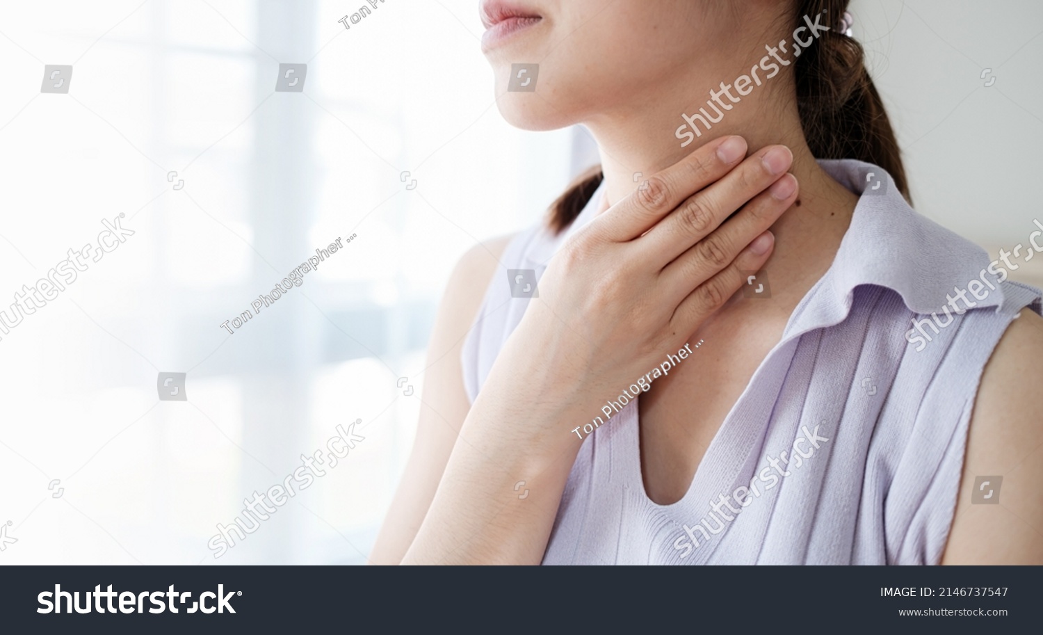 Woman with sore throat inflamed tonsils from influenza symptoms. Healthcare and medical concept #2146737547