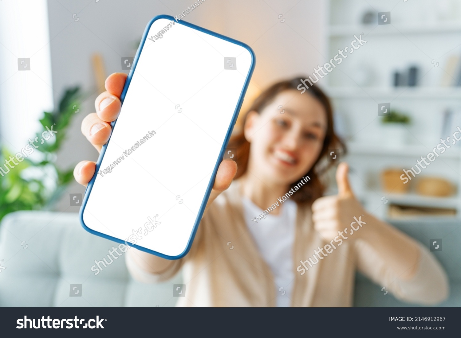 Woman showing smartphone. Blank screen mobile phone for graphic montage. #2146912967