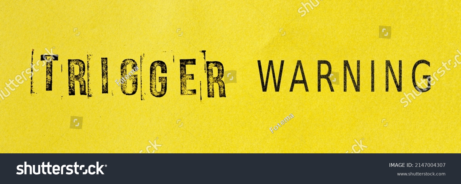Trigger warning sign message on yellow background. Stamp letters mental triggering concept. #2147004307