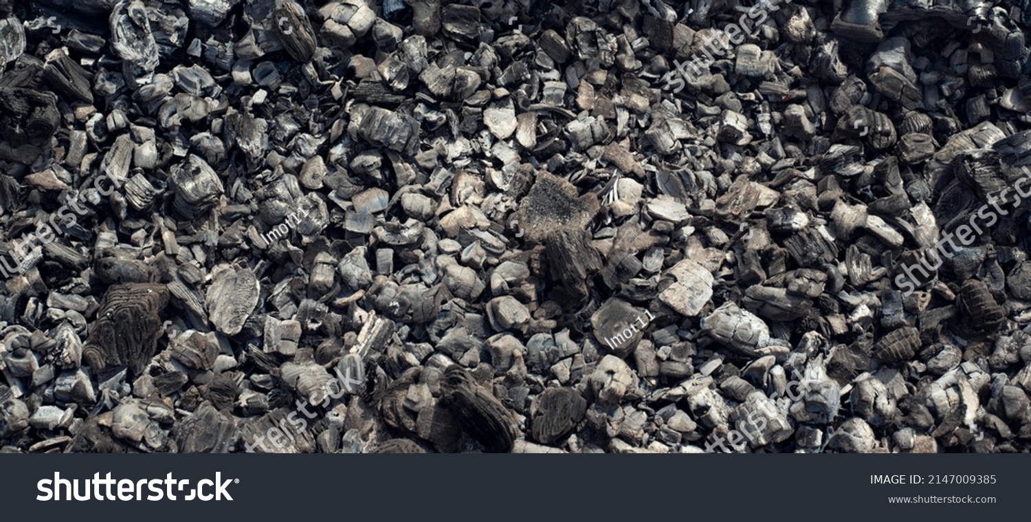 A background of scattered charcoal. Burning coal. Smoldering coal.  #2147009385