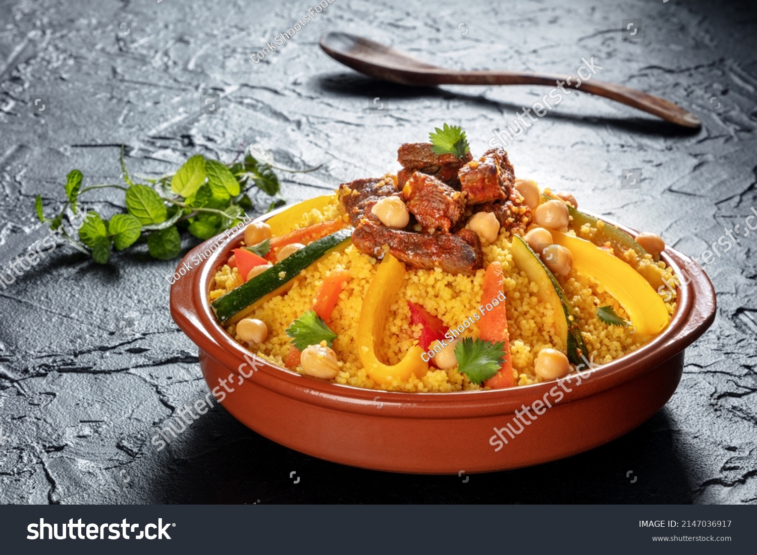 Meat and vegetable couscous in a bowl, typical food from Morocco, a traditional festive Arabic dish with herbs and spices #2147036917