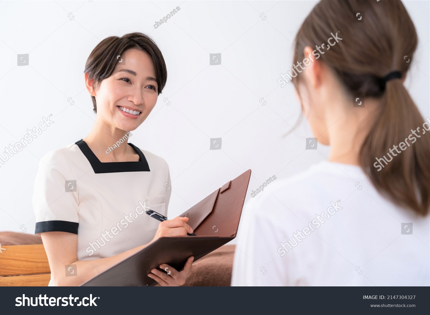 Asian women receiving courteous counseling #2147304327