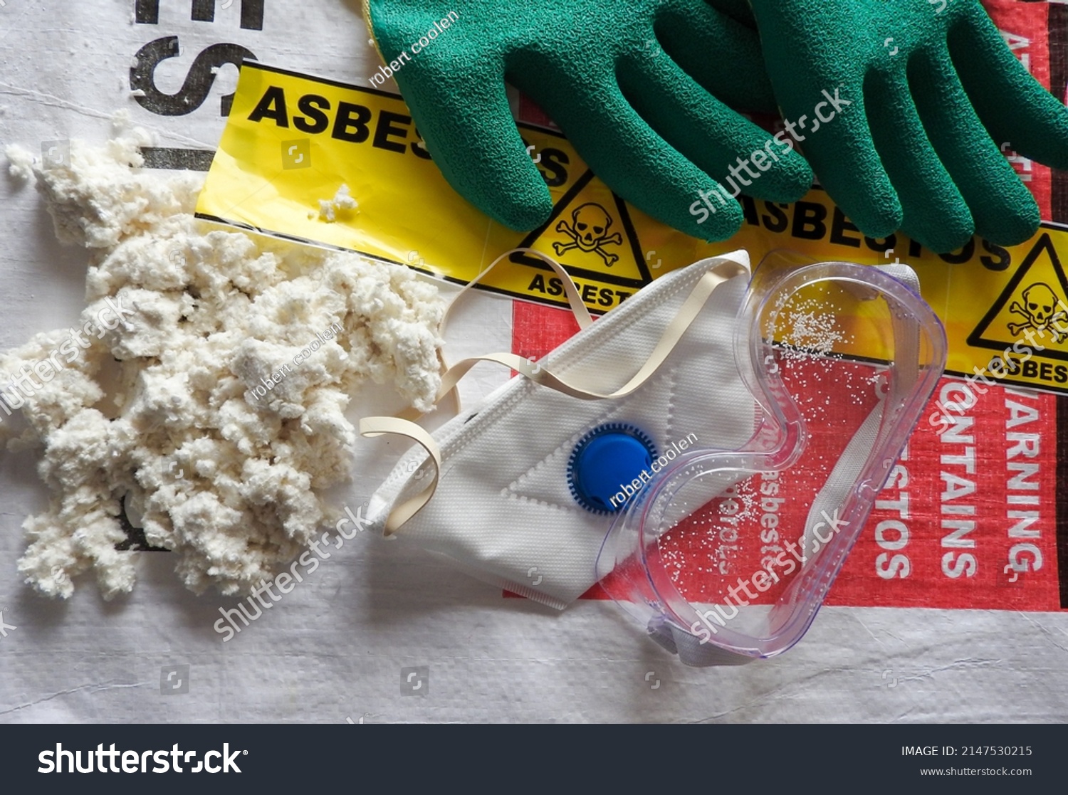 Close up asbestos, fibers, mask, filter, gloves and goggles. Bag in background. Barrier tape, warning forbidden acces, hazard. Asbestos removal. Asbestosis, lungcancer, mesothelioma. Protection, serie #2147530215