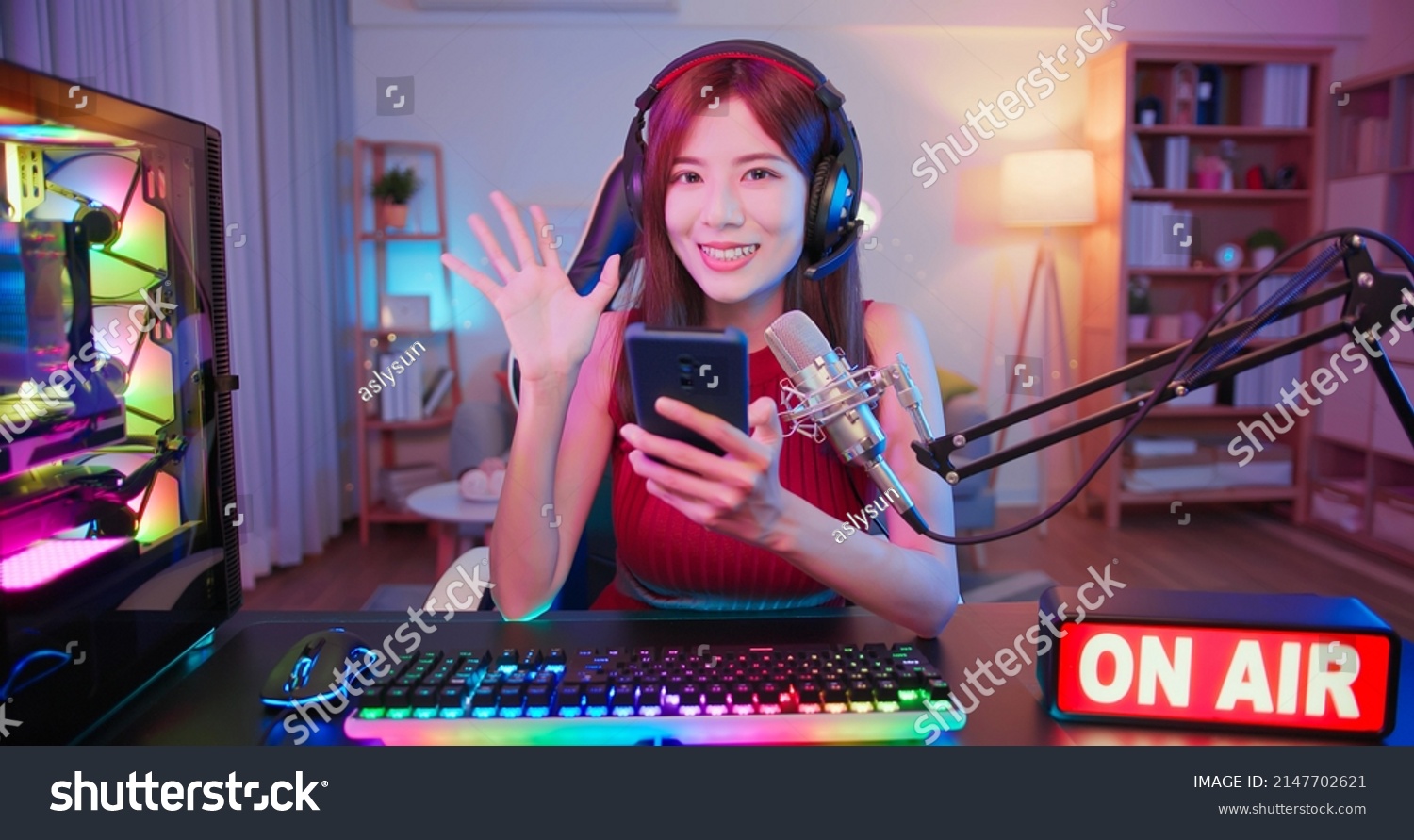 asian female cybersport gamer have live stream with on air light sign and playing mobile game by the smartphone at home #2147702621