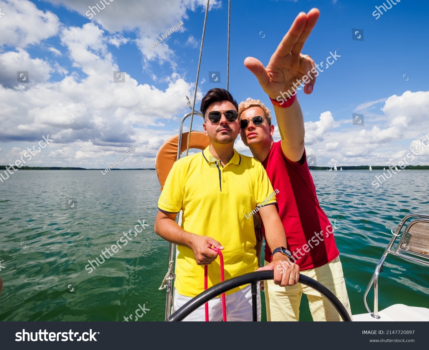 young person point forward his hand to his friend the direction of sailing on sailing yacht. summer vacations on sailing yacht #2147720897