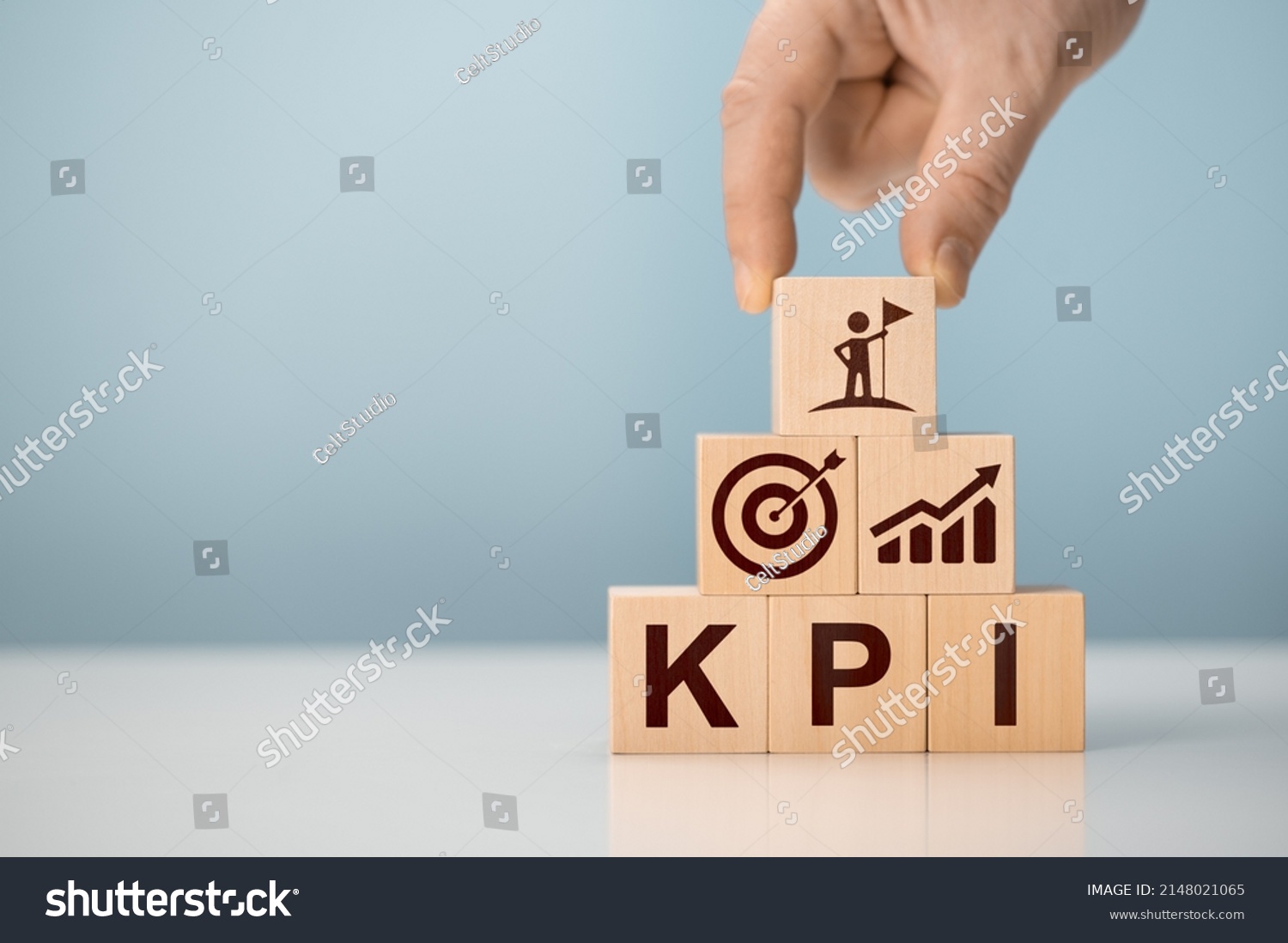 KPI - Key Performance Indicator. Businessman holds cube with KPI icon, KPI key performance indicator increase optimisation business. Business planning and measure success, target achievement. #2148021065