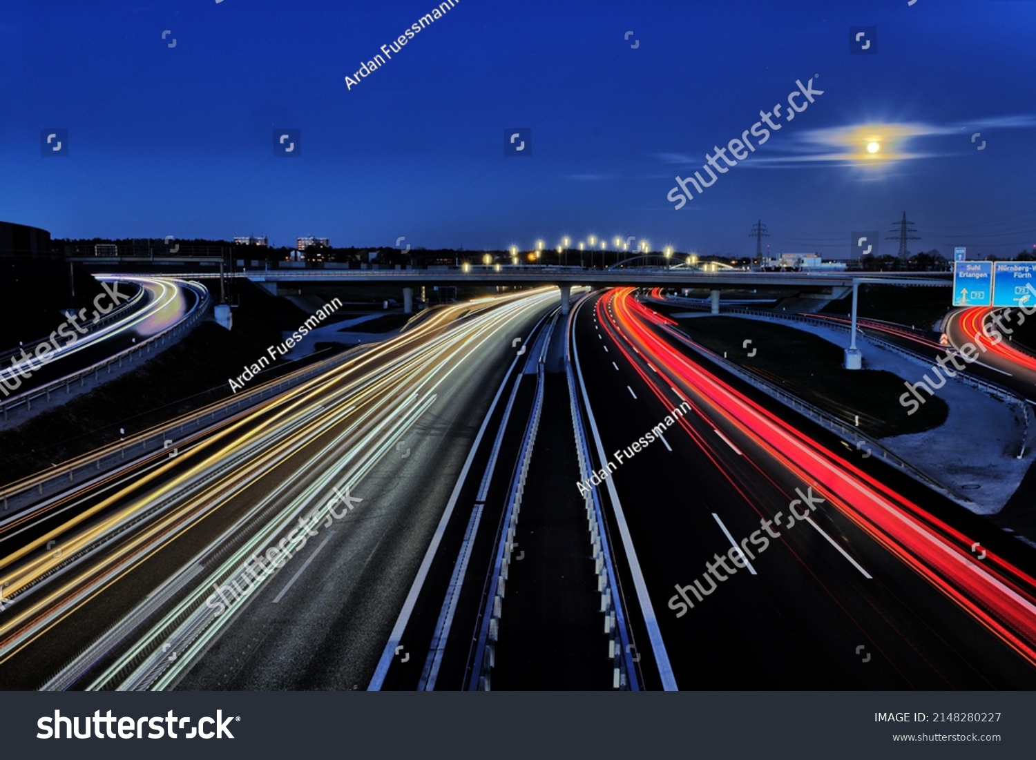 Freeway traffic on German roads at night - light trays during sun set and blue hour #2148280227